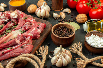 front view raw meat slice with fresh vegetables and seasonings on dark background salad butcher cooking raw meat dish meal