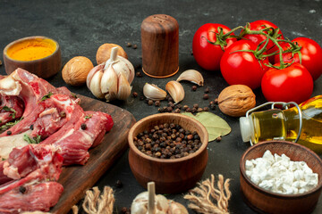 front view raw meat slice with fresh vegetables and seasonings on the dark background salad butcher cooking raw meat dish meal