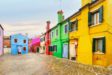 Fototapeta na wymiar Colorful houses on Burano island, Venice Italy. Is an island in the Venetian Lagoon and is known for its lace work and brightly colored homes.