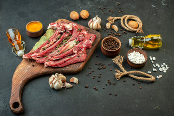 front view raw meat slice with seasonings on dark background salad meat butcher cooking raw dish meal