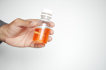 holding a antipyretic syrup bottle 