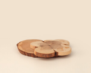 Wooden eco rustic pine tree wood circle disc platform podium on light beige background. Minimal empty display product presentation scene.