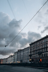 Canal embankment in the city in the evening. Bridges and beautiful buildings.