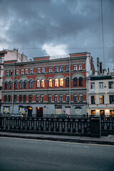 Canal embankment in the city in the evening. Bridges and beautiful buildings.