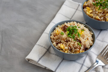 Homemade Fried Rice with Bacon and Egg in a Bowl, side view. Space for text.