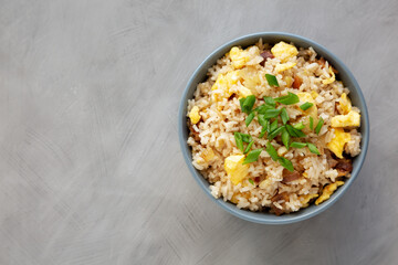 Homemade Fried Rice with Bacon and Egg in a Bowl, top view. Flat lay, overhead, from above. Copy space.
