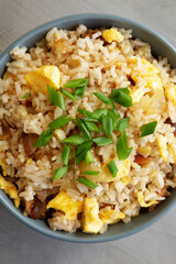 Homemade Fried Rice with Bacon and Egg in a Bowl, top view. Flat lay, overhead, from above. Close-up.