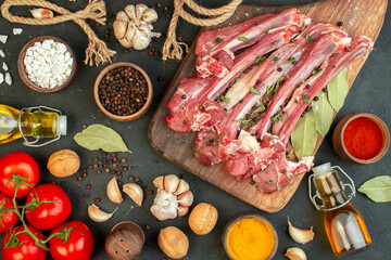 top view raw meat slice with different seasonings on the dark background salad butcher cooking raw meat dish meal