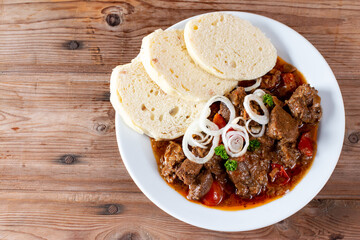 Fine Meat - Beef Goulash in a with Red Pepper on table. Top view. Copy space