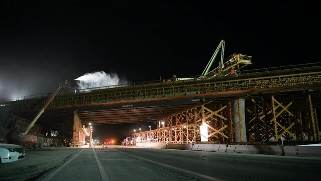 Construction Crew Pours Concrete Bridge at Night