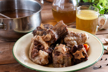 Beef bones to make bone broth for a healthy diet. Saucepan with bone broth.