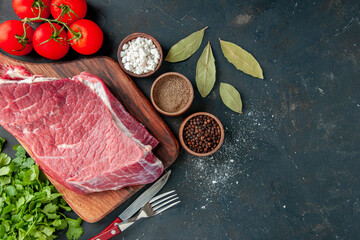 top view raw meat slice with red tomatoes and greens on the dark background color butcher food meat food barbecue cooking meal