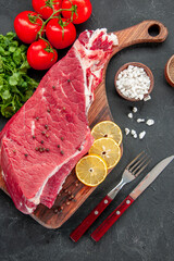 top view raw meat slice with red tomatoes and greens on the dark background cooking butcher dish food meat salad barbecue color dinner