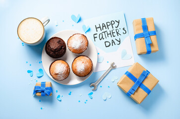 Happy Father's Day Concept, Greeting card, Father's Day Breakfast with morning coffee, muffins, gift boxes, letter on light blue background