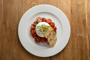 delicious buratta cheese on a white plate
