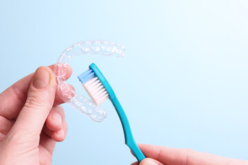 Cleaning plastic aligner aligners with a toothbrush 