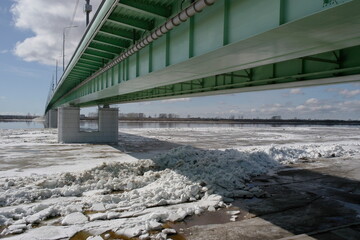 ice drift on the river in spring near the automobile bridge