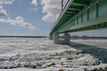 ice drift on the river in spring near the automobile bridge