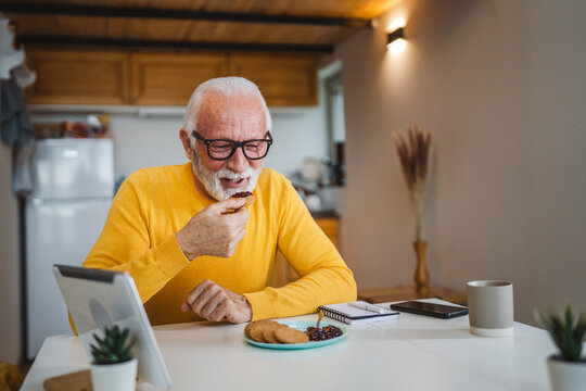 Senior caucasian Man Enjoy Breakfast at Home with Jam and Biscuit