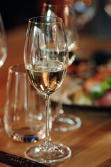 glass of dry White wine ripe grapes and bread on table in vineyard