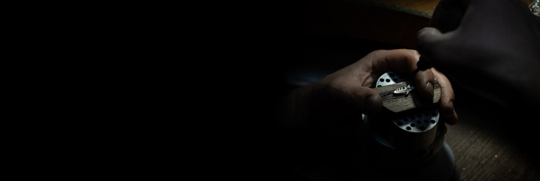 Different goldsmiths tools on the jewelry workplace. Jeweler at work in jewelry. Desktop for craft jewelry making with professional tools. Close up view of tools.