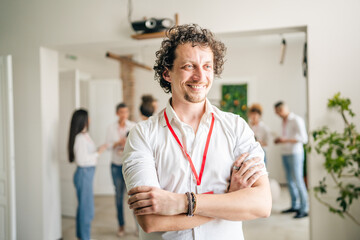 man caucasian male stand in front of group of happy smile at work