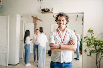 man caucasian male stand in front of group of happy smile at work