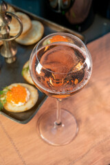 Tasting of rose brut Champagne sparkling wine with red caviar in cellars of gran cru wine house in Epernay, wine tour in Champagne, France