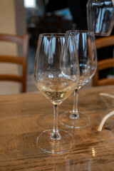 Tasting of cold brut Champagne sparkling wine in cellars of gran cru wine house in near Reims, wine tour in Champagne, France