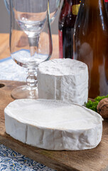 Belgian white mold soft cow milk cheeses Bouquet des Moines and creamy cheese and bottles of different Belgian beer