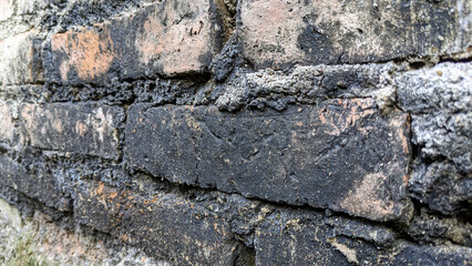 blackened texture of brick wall. Dirty red grunge brick wall