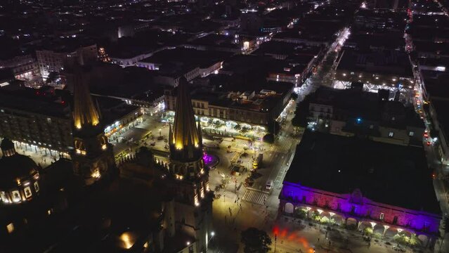 Beautiful night scene with historic architecture Guadalajara Cathedral at purple sky. Overhead view of central plaza of Guadalajara Mexico. Aerial Cathedral and Plaza Guadalajara in Jalisco, Mexico 4K
