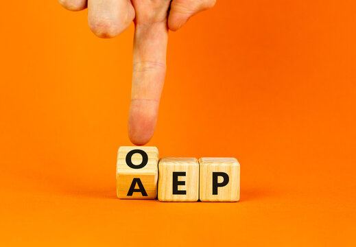 AEP or OEP symbol. Concept words AEP annual enrollment period OEP open enrollment period. Doctor hand. Beautiful orange background. Medical annual or open enrollment period concept. Copy space.