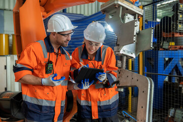 Team of engineers or technicians check stock and check the integrity of intelligent robotic arm...
