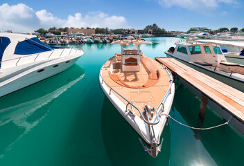 United Arab Emirates, Abu Dhabi waterfront marina in downtown with yachts and water sport activity.