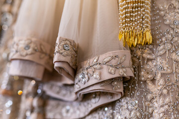 Indian bride's creamy wedding outfit close up