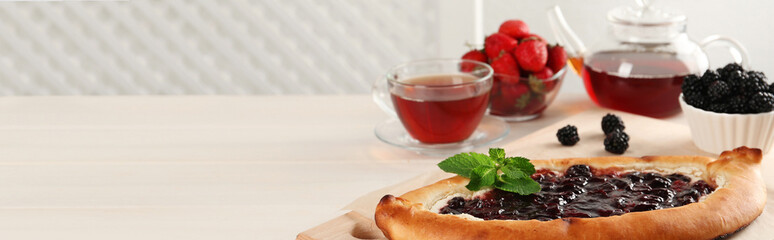 Delicious sweet cottage cheese pastry with jam served on white wooden table, banner design. Space for text