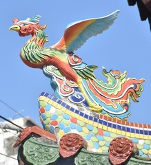 Colourful phoenix statue on the top of a Chinese temple