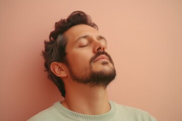 Fototapeta premium Handsome young man with beard and mustache relaxing on pink background