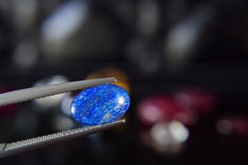 Lapis Is a beautiful natural gemstone on a wooden floor.
