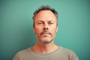 Obraz premium Portrait of a middle-aged man on a blue background.