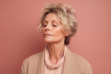 Fototapeta premium Portrait of a beautiful middle aged woman with short blonde hair.