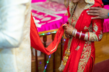 Indian Punjabi wedding ceremony bride and groom's hands close up - obrazy, fototapety, plakaty