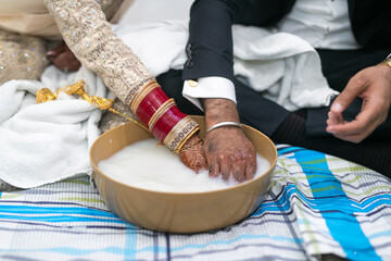 Indian Punjabi post wedding ceremony pani varna and doli hands close up - obrazy, fototapety, plakaty