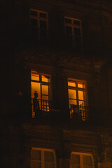silhouette of a man in a European window at night