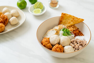 spicy small flat rice noodles with fish balls and shrimp balls without soup