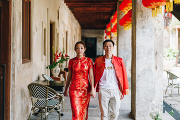 Happy young Asian couple in Chinese traditional dresses
