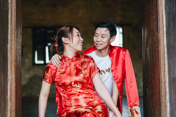 Happy young Asian couple in Chinese traditional dresses