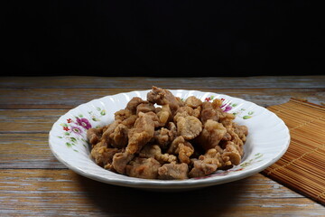 Traditional deep fried pork belly serving on the plate. Famous crispy and crunchy appetizer menu in Asia restaurant.