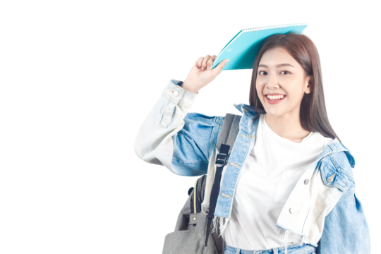 Portrait of smiling Asian female student in university wearing denim shirt standing holding a book on top of his head. PNG file format isolated on transparent background